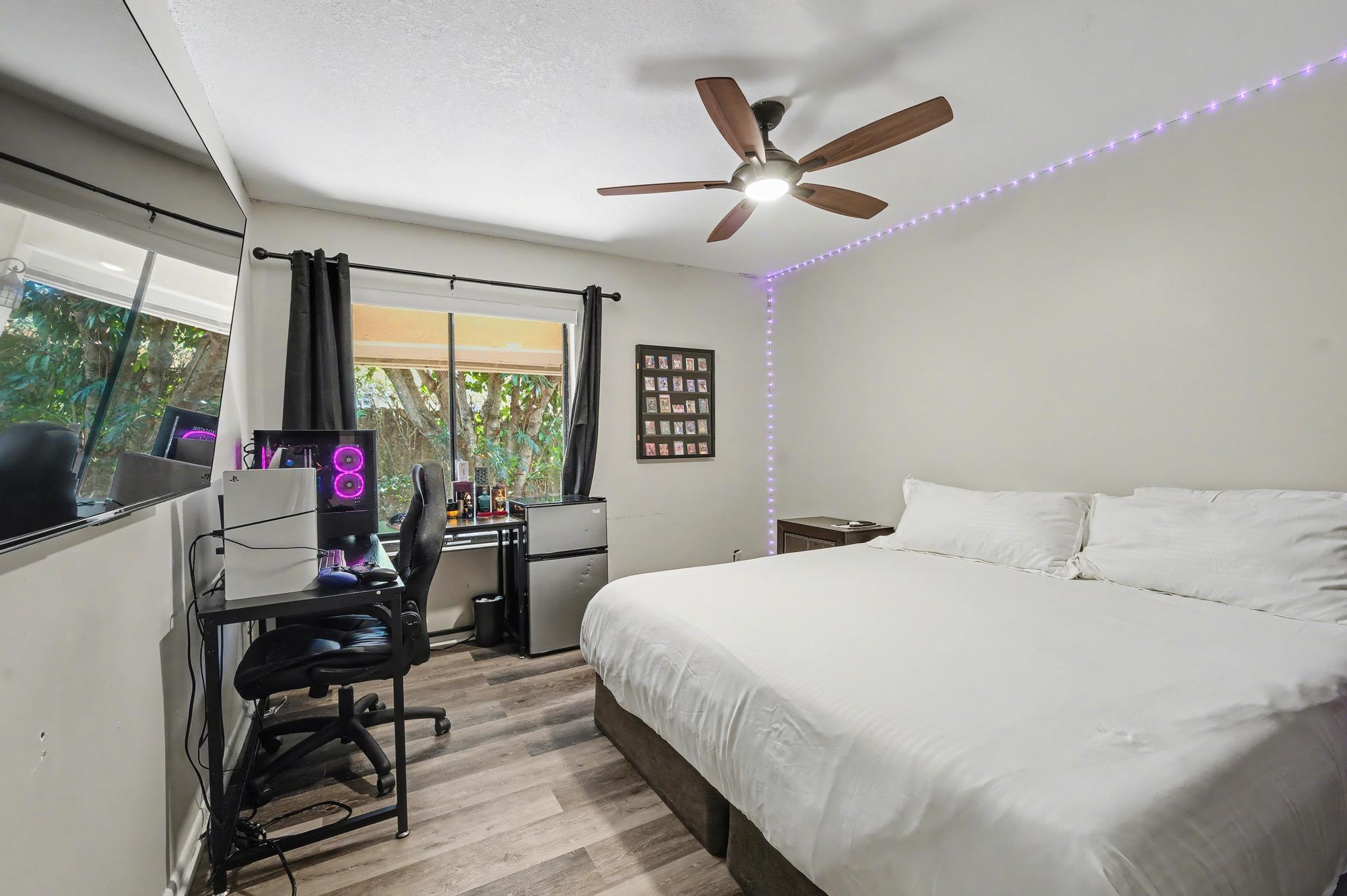 7855 Stanway Place Boca Raton, FL 33433 - Photo 17 of 24 a bedroom with a bed a large window and wooden floor