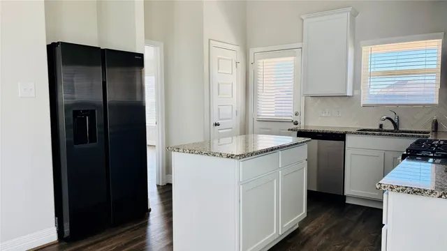 a kitchen with a sink and a refrigerator