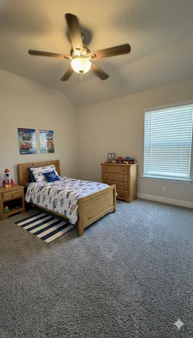 a spacious bedroom with a bed and a chandelier