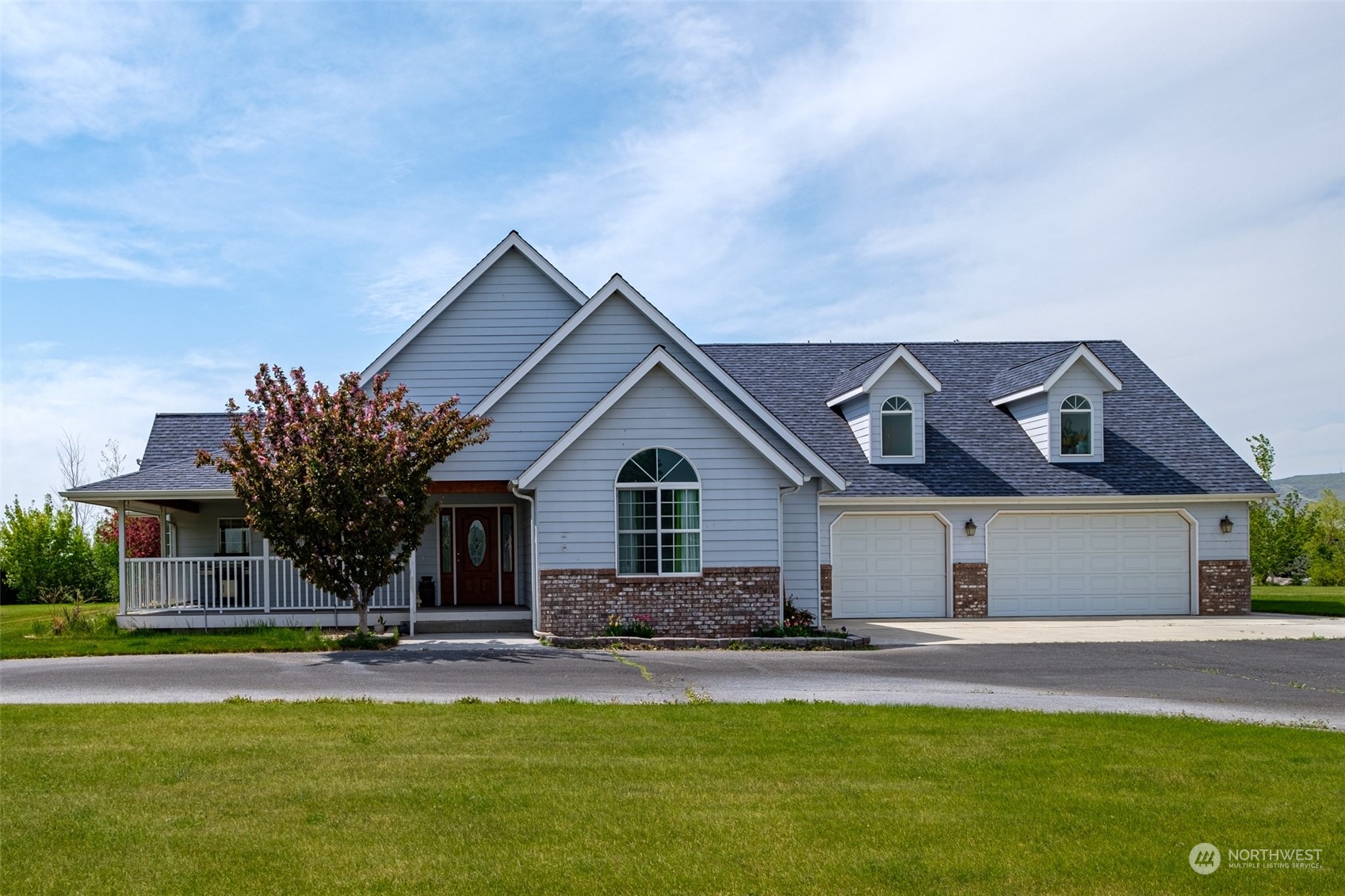 a front view of a house with swimming pool and porch with seating