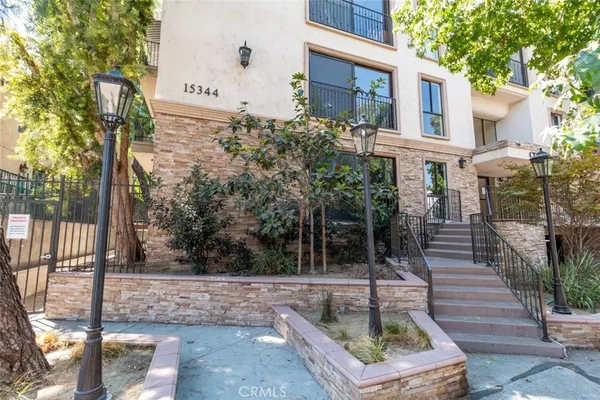 a house with potted plants in front of it