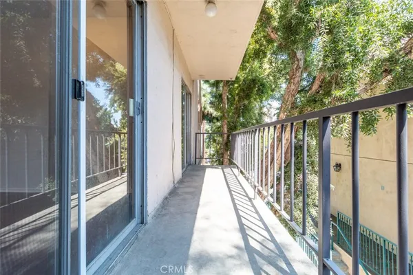 a view of balcony with wooden floor and fence