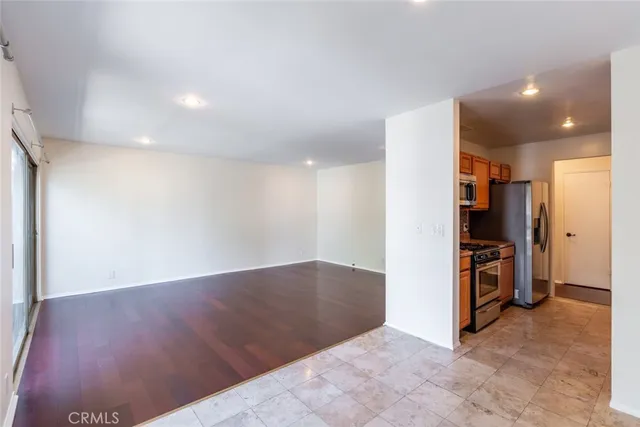 a view of a kitchen with a sink and a refrigerator