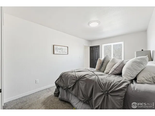 a bedroom with a bed and a night stand