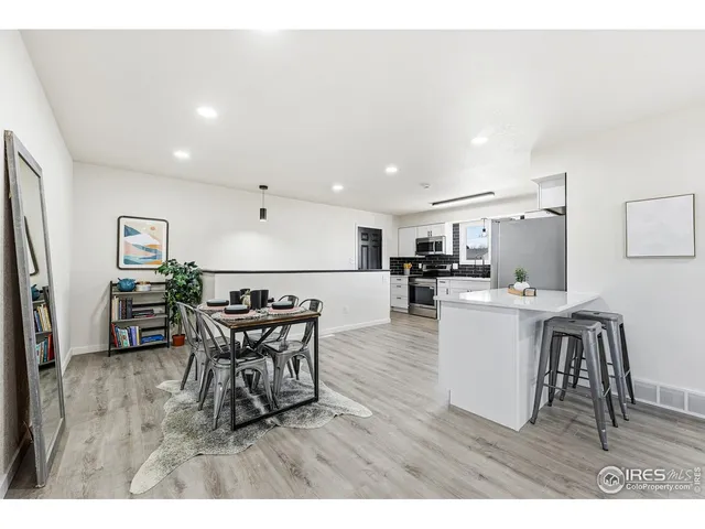 a living room with furniture and kitchen view
