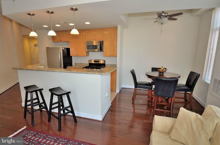 3650 South Glebe Road, Unit 638 Arlington, VA 22202 - Photo 2 of 24 a dining room with furniture and wooden floor