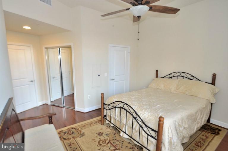 3650 South Glebe Road, Unit 638 Arlington, VA 22202 - Photo 5 of 24 a bedroom with a bed and wooden floor