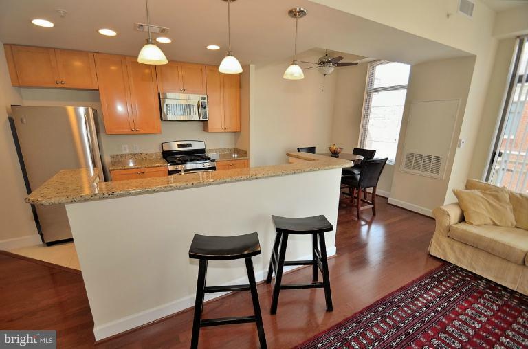 3650 South Glebe Road, Unit 638 Arlington, VA 22202 - Photo 10 of 24 a view of a dining room with furniture and wooden floor
