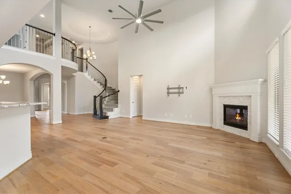 a view of empty room with wooden floor and fireplace