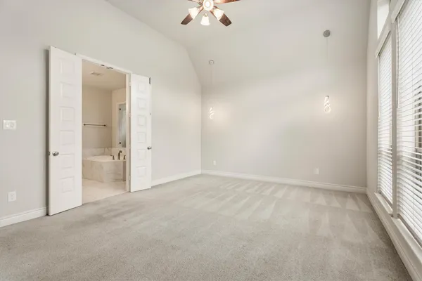 an empty room with a empty space and a ceiling fan