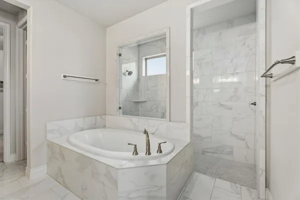 a white bath tub sitting next to a shower
