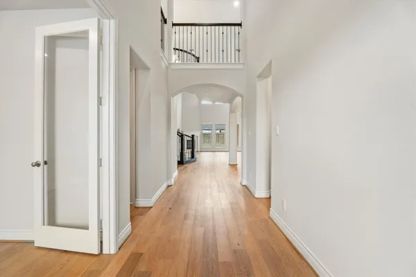 a view of a hallway with wooden floor