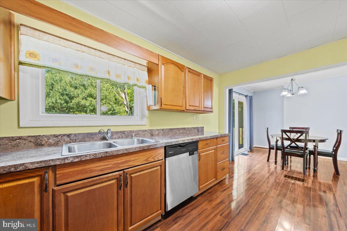 3 High Ridge Drive Pemberton, NJ 08068 - Photo 8 of 24 a kitchen with stainless steel appliances granite countertop a table chairs stove and sink