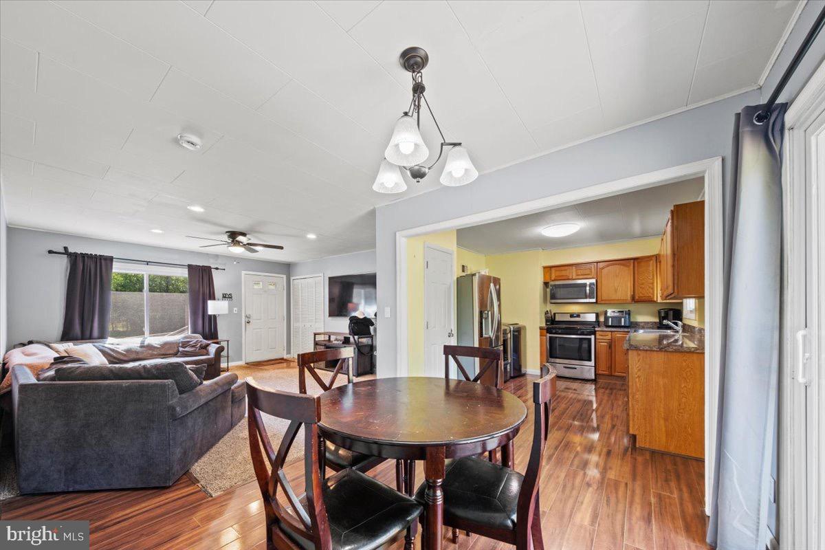 3 High Ridge Drive Pemberton, NJ 08068 - Photo 10 of 24 a view of a dining room and livingroom with furniture wooden floor a chandelier