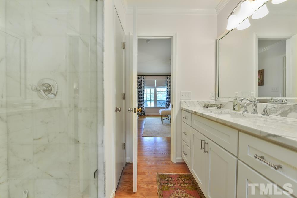 1504 Rolesville Road Wake Forest, NC 27587 - Photo 17 of 21 a bathroom with a granite countertop sink two mirror and shower