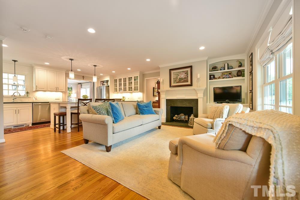 1504 Rolesville Road Wake Forest, NC 27587 - Photo 3 of 21 a living room with furniture a fireplace and a flat screen tv