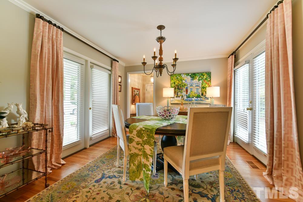 1504 Rolesville Road Wake Forest, NC 27587 - Photo 9 of 21 a dining room with furniture a chandelier and wooden floor