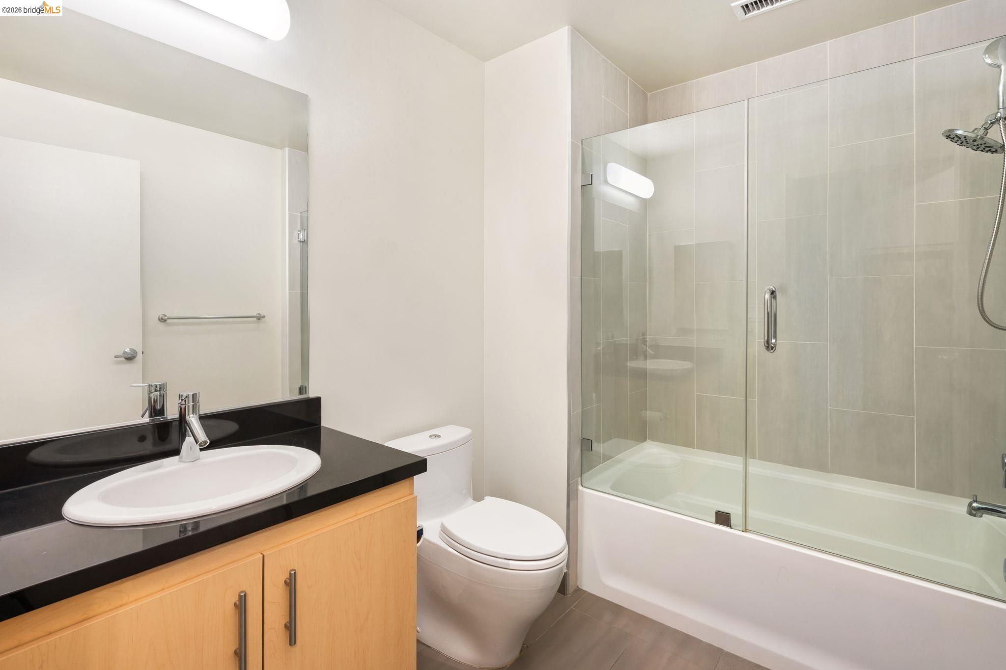 311 2nd Street, Unit 511 Oakland, CA 94607 - Photo 11 of 44 Bathroom featuring vanity and combined bath / shower with glass door