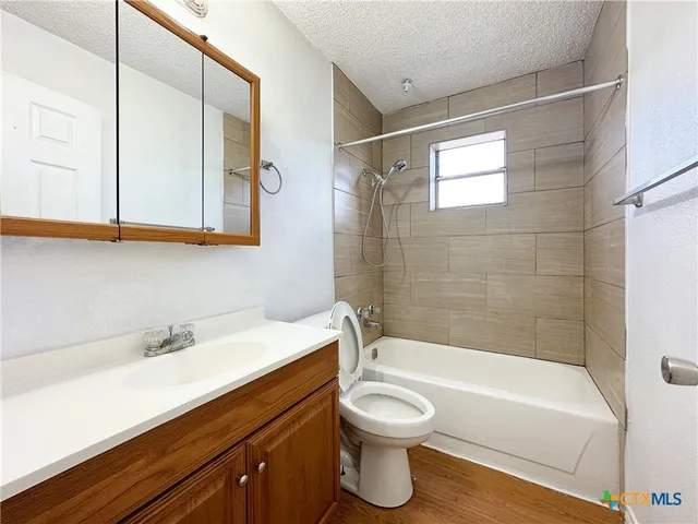 a bathroom with a sink a toilet and bathtub