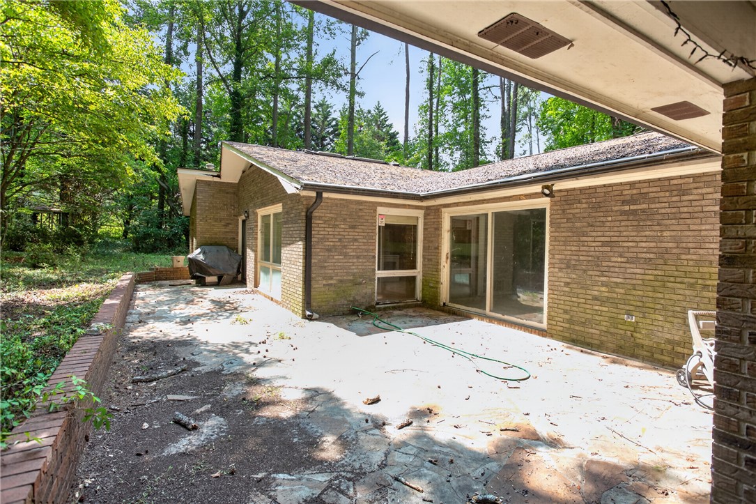 123 Robin Road Westminster, SC 29693 - Photo 7 of 50 A spacious brick patio bordered by mature trees offers a private outdoor retreat.