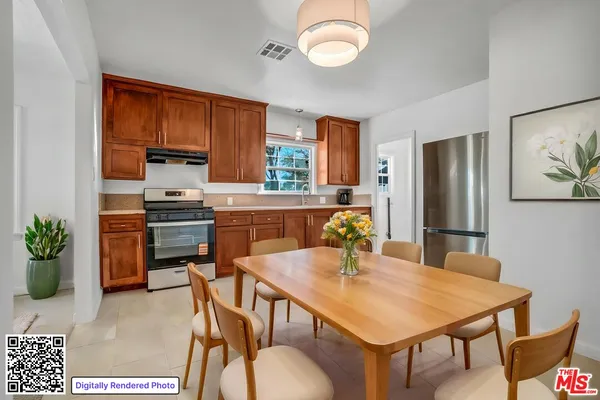 a kitchen with a table chairs refrigerator and microwave