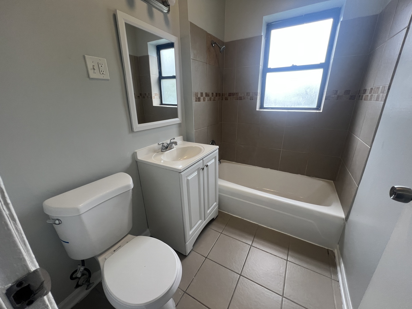 71 East 69th Street, Unit 2 Chicago, IL 60637 - Photo 6 of 6 a white toilet sitting next to a bath tub