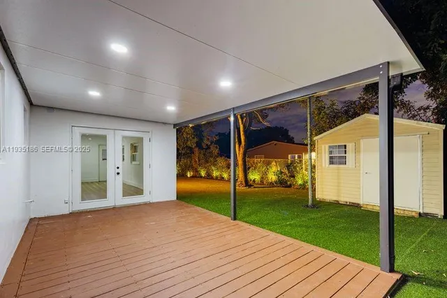 a view of a porch with wooden floor and door