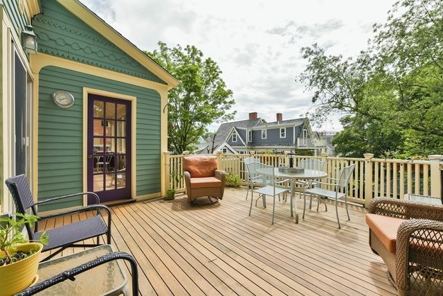 a view of a patio with couches table and chairs and potted plants