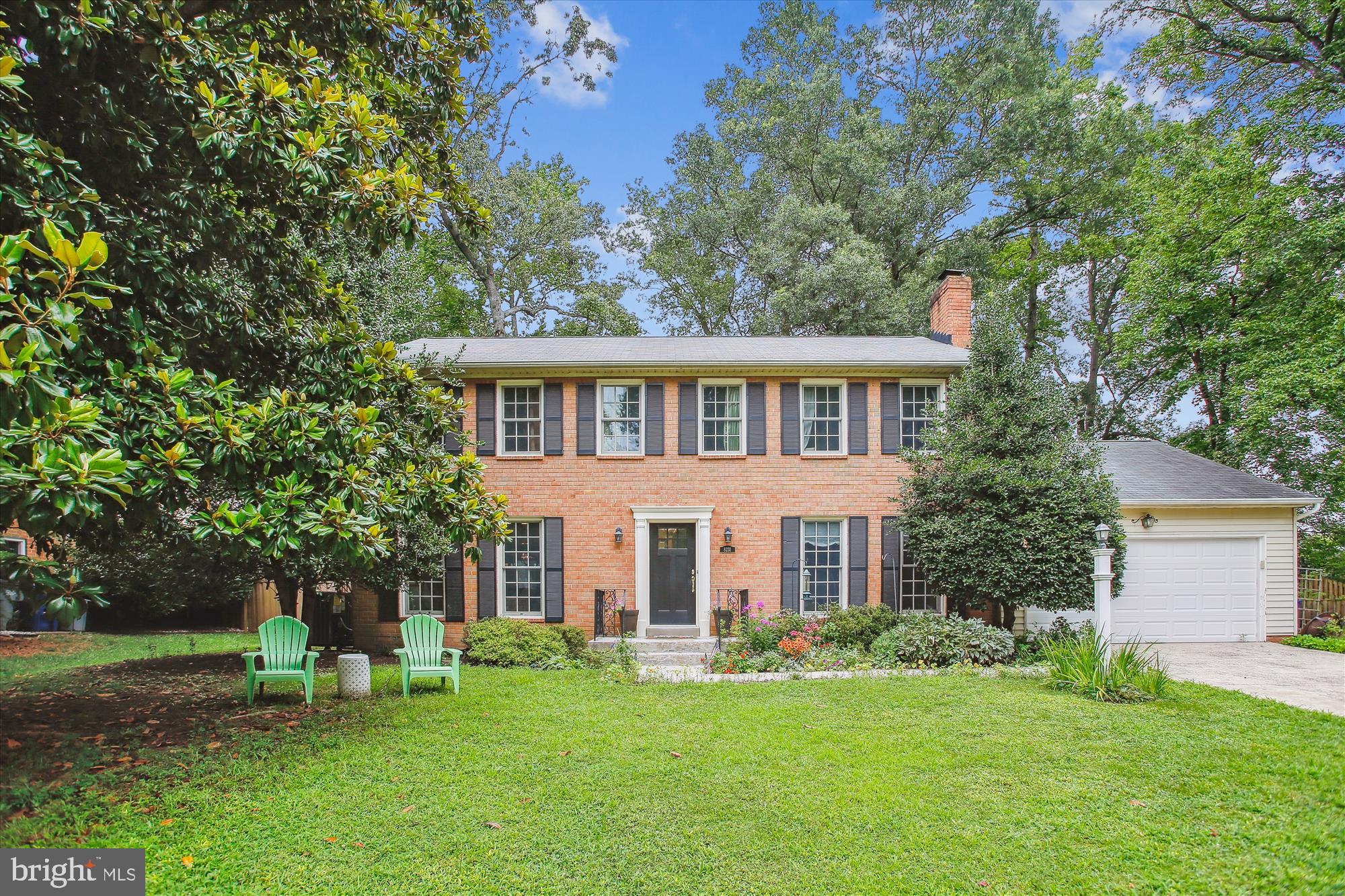 a view of a house with a yard and sitting area