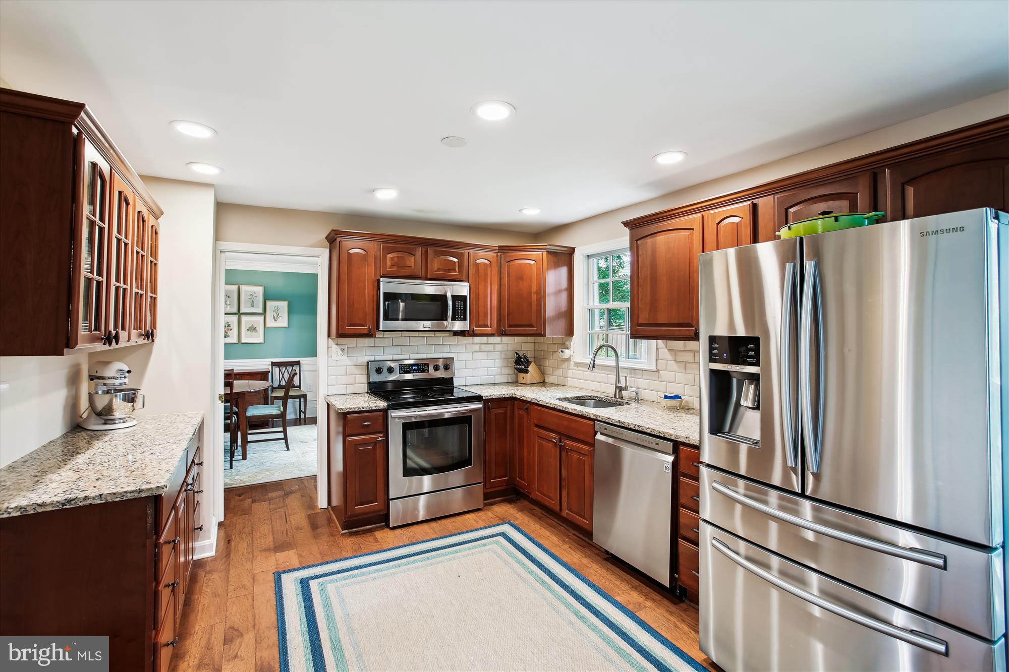8231 Crown Court Road Alexandria, VA 22308 - Photo 11 of 33 a kitchen with stainless steel appliances granite countertop a refrigerator a stove top oven a sink and dishwasher