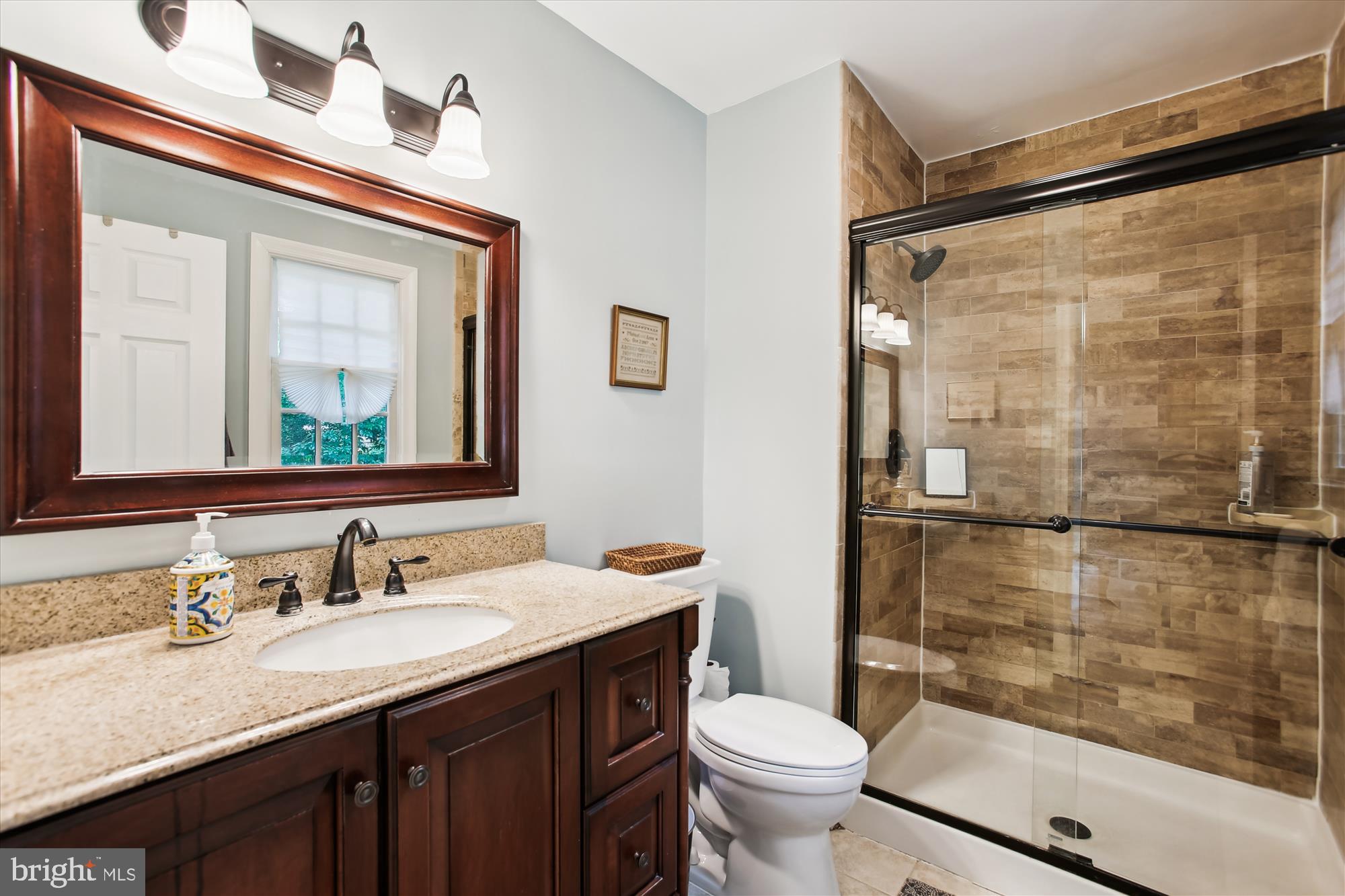 8231 Crown Court Road Alexandria, VA 22308 - Photo 20 of 33 a bathroom with a granite countertop sink toilet and shower