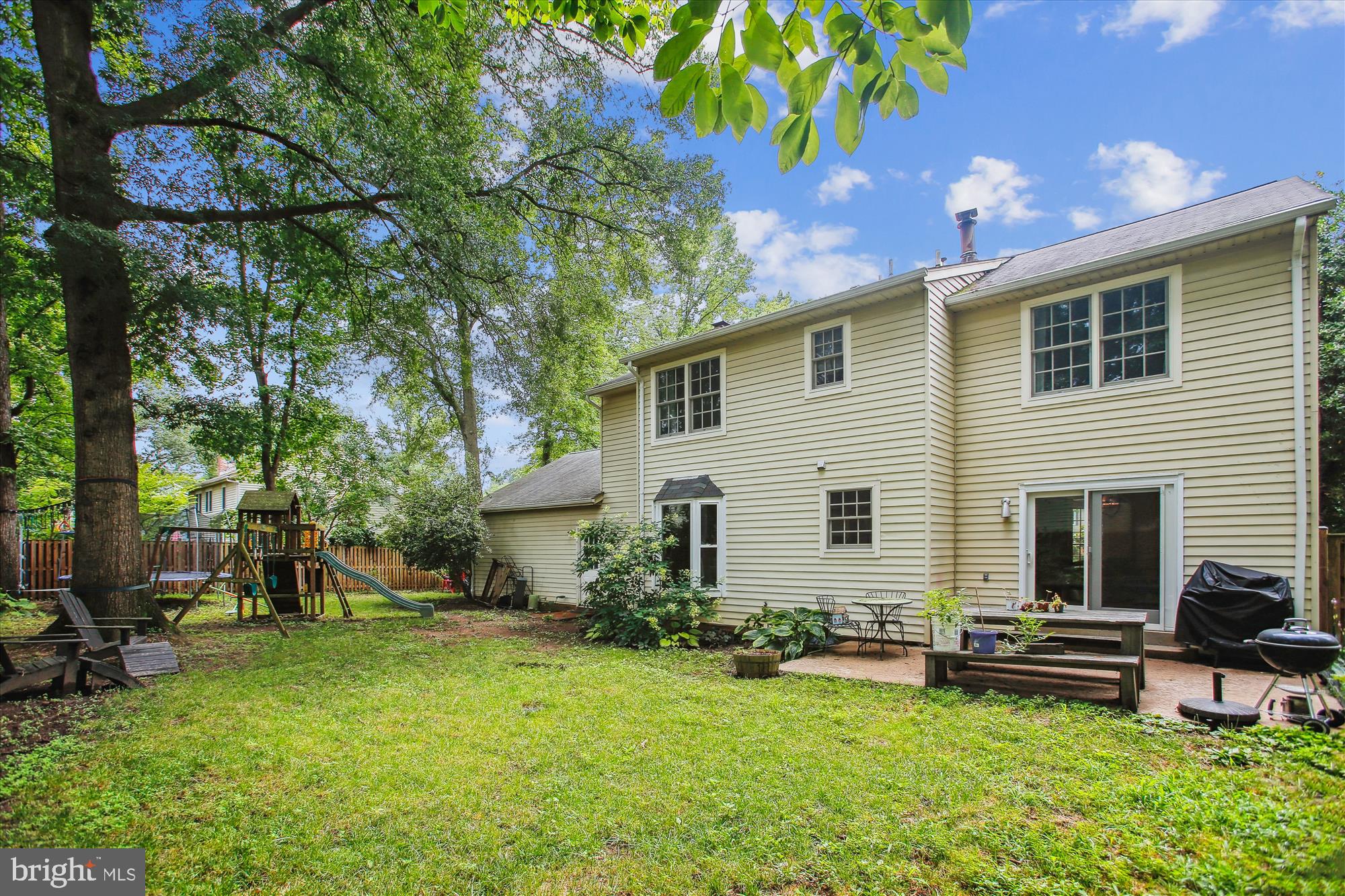 8231 Crown Court Road Alexandria, VA 22308 - Photo 32 of 33 a backyard of a house with table and chairs