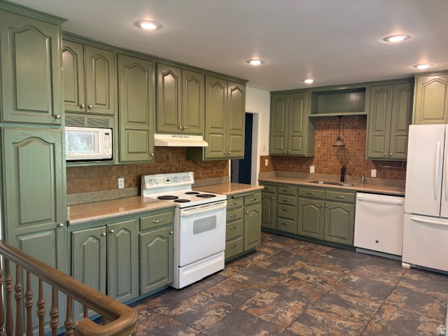 2313 150 East Bountiful, UT 84010 - Photo 9 of 39 Kitchen featuring extensive sage-toned cabinetry, light-toned countertops, and a full tile backsplash