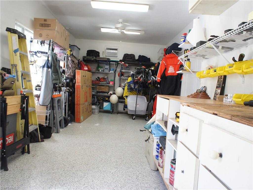 6840 Sable Ridge Lane Naples, FL 34109 - Photo 13 of 38 Workshop/Storage with a ceiling fan and a wall mounted AC