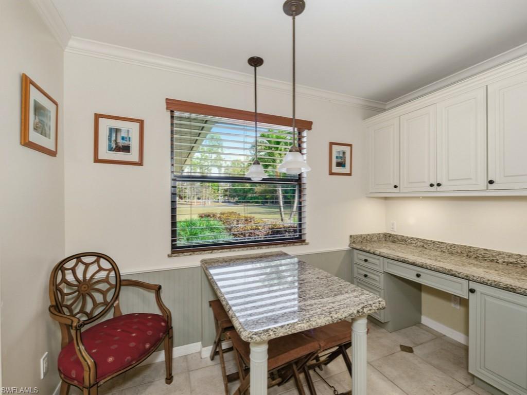 6840 Sable Ridge Lane Naples, FL 34109 - Photo 19 of 38 Dining space featuring wainscoting, crown molding, and light tile patterned flooring
