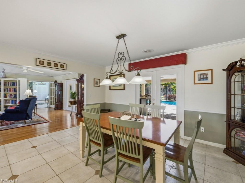 6840 Sable Ridge Lane Naples, FL 34109 - Photo 20 of 38 Dining room with french doors, light tile patterned floors, and ornamental molding