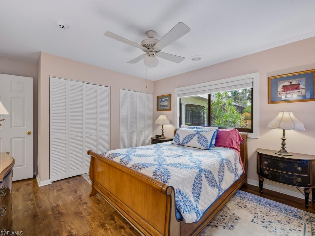 6840 Sable Ridge Lane Naples, FL 34109 - Photo 22 of 38 Bedroom 2 with multiple closets, dark wood-style flooring, and ceiling fan