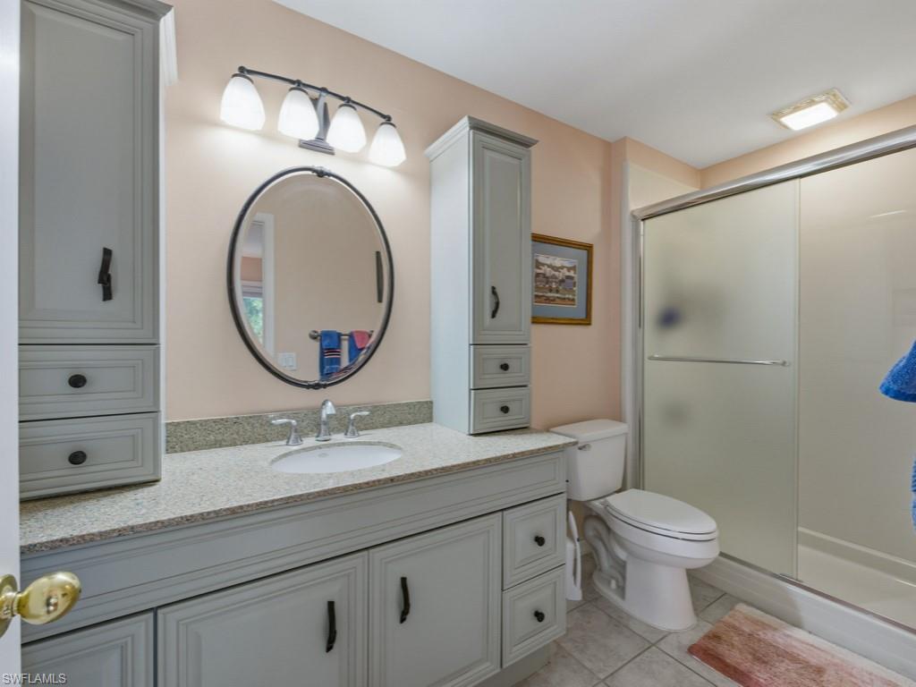 6840 Sable Ridge Lane Naples, FL 34109 - Photo 23 of 38 Full bath with vanity, a shower stall, and light tile patterned floors
