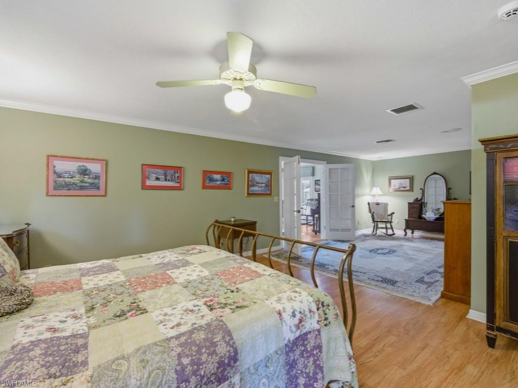 6840 Sable Ridge Lane Naples, FL 34109 - Photo 28 of 38 Bedroom featuring french doors, crown molding, light wood finished floors, and ceiling fan