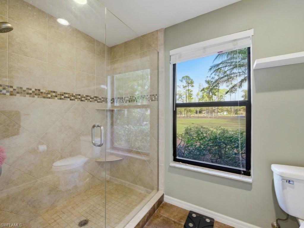 6840 Sable Ridge Lane Naples, FL 34109 - Photo 30 of 38 Bathroom featuring a shower stall and tile patterned flooring