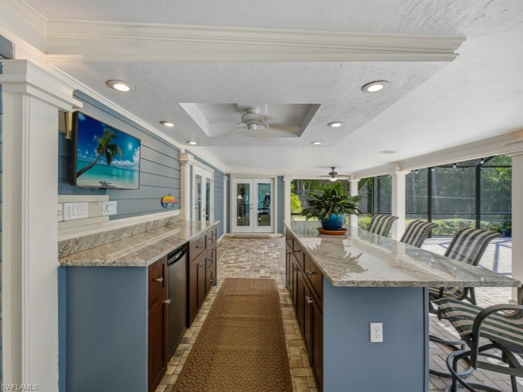 6840 Sable Ridge Lane Naples, FL 34109 - Photo 33 of 38 View of patio / terrace with area for grilling, ceiling fan, french doors, and glass enclosure