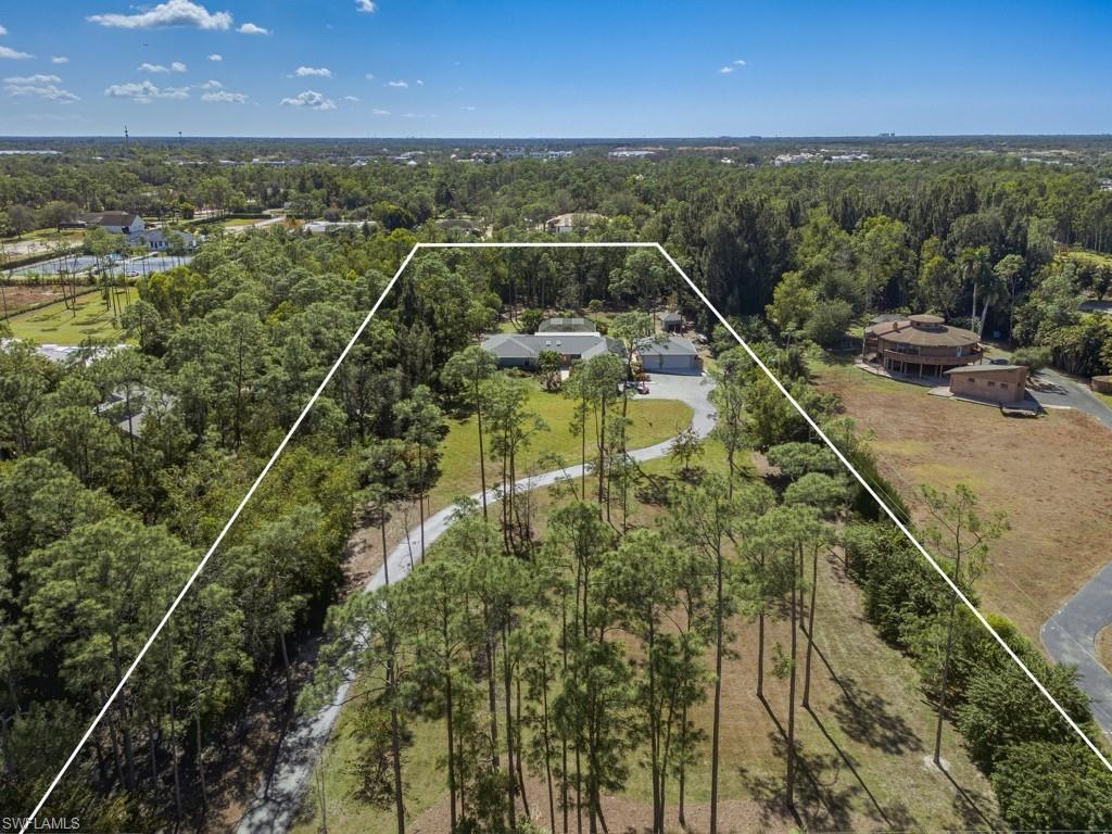 6840 Sable Ridge Lane Naples, FL 34109 - Photo 7 of 38 Aerial view of property and surrounding area featuring a heavily wooded area and property parcel outlined