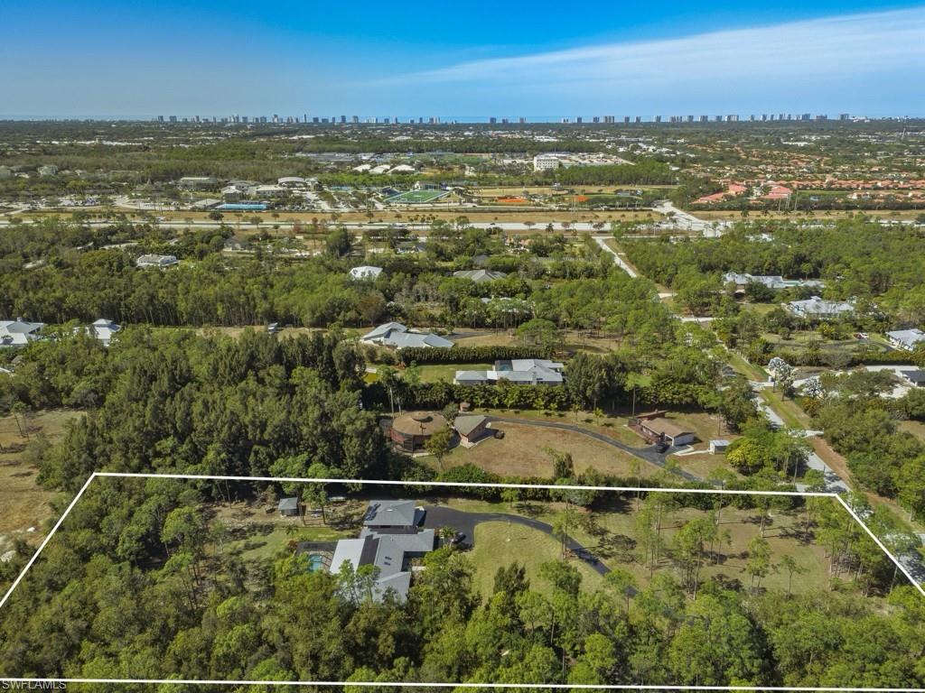 6840 Sable Ridge Lane Naples, FL 34109 - Photo 10 of 38 Aerial view of property's location featuring property parcel outlined and city skyline