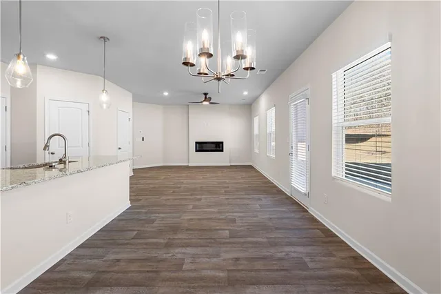 a view of a kitchen with a sink wooden floor and a large window
