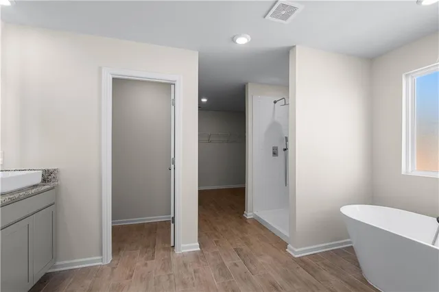 a bathroom with a bathtub and shower