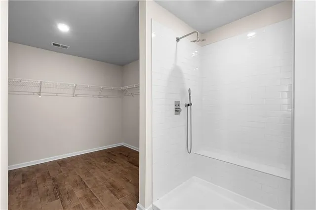 a view of a room with wooden floor