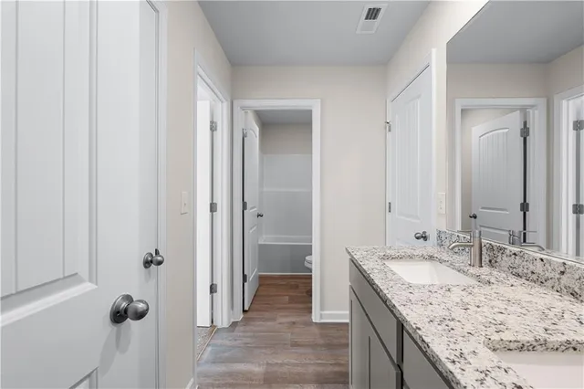 a white toilet sitting next to a bath tub