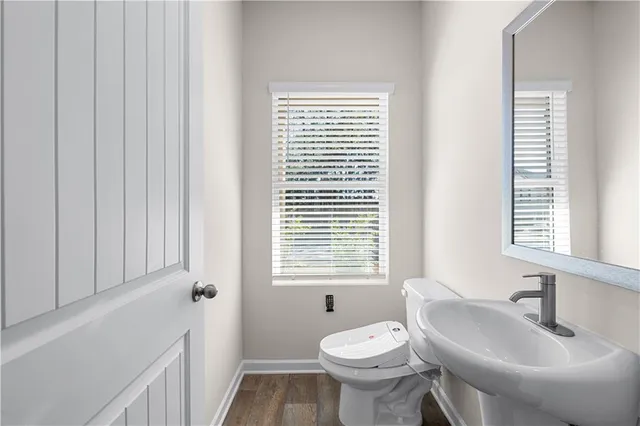 a bathroom with a sink toilet and a mirror