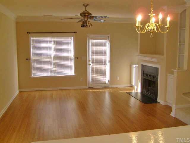 2352 Persimmon Ridge Drive Raleigh, NC 27604 - Photo 5 of 12 a view of an empty room with chandelier and fireplace