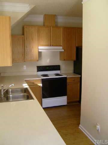 2352 Persimmon Ridge Drive Raleigh, NC 27604 - Photo 6 of 12 a kitchen with a stove and a sink